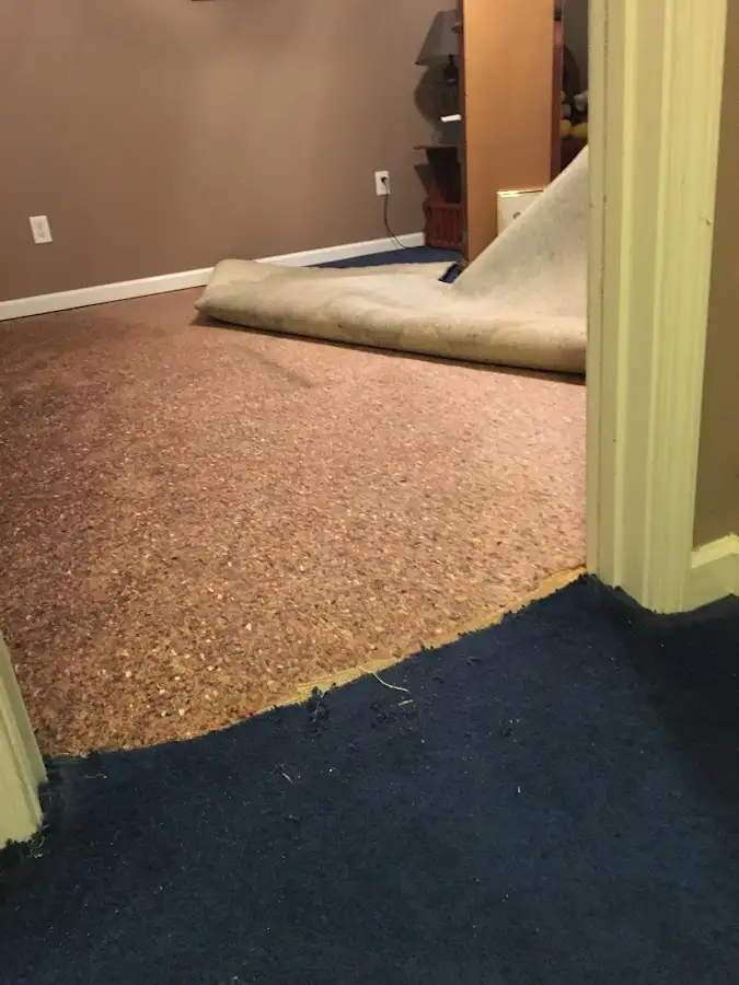 Carpet pad removal revealing water damage during Drying & Dehumidification in Urbandale
